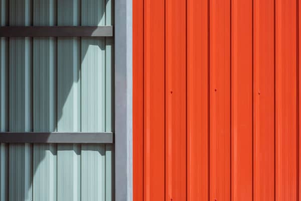 Sunlight And Shadow On Steel Garage Wall With Oran